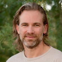 Headshot of Mark Dorison in a tan shirt